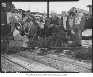 Children watching fisherman Hegerberg repair net at Fisherman's Terminal, Seattle, 1949